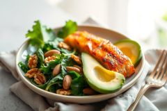 Delicious salmon salad with avocado and pecans on a plate. A healthy and vibrant meal with green salad, creamy avocado, and golden pecans.