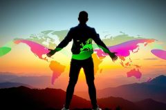 The image depicts a person standing with their arms outstretched in front of them, facing away from the camera. They appear to be on a mountain top or similar high-altitude location. 